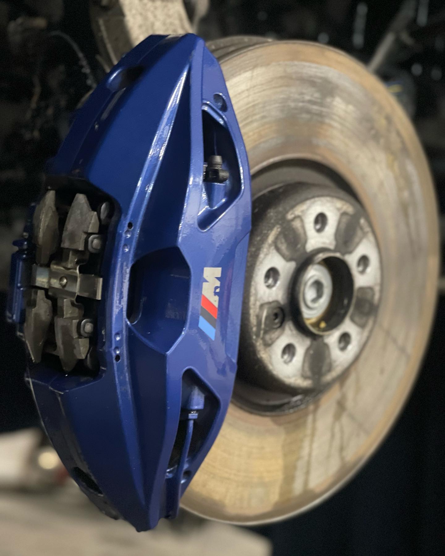 BMW M brake caliper being detailed and refinished