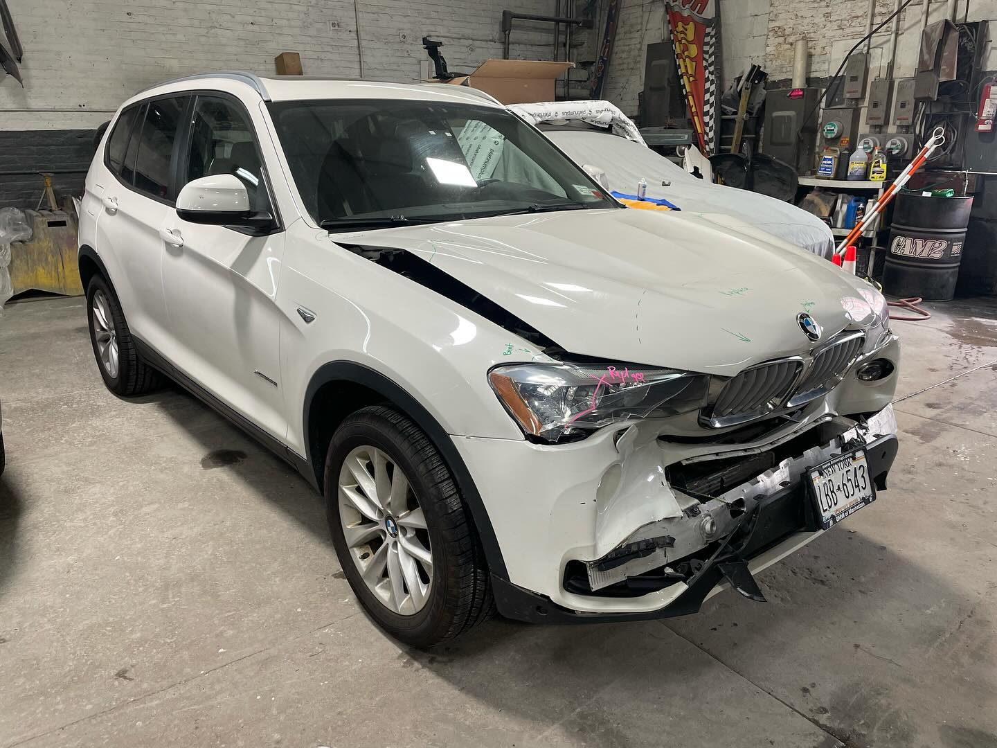BMW X3 rear-quarter collision damage before repair