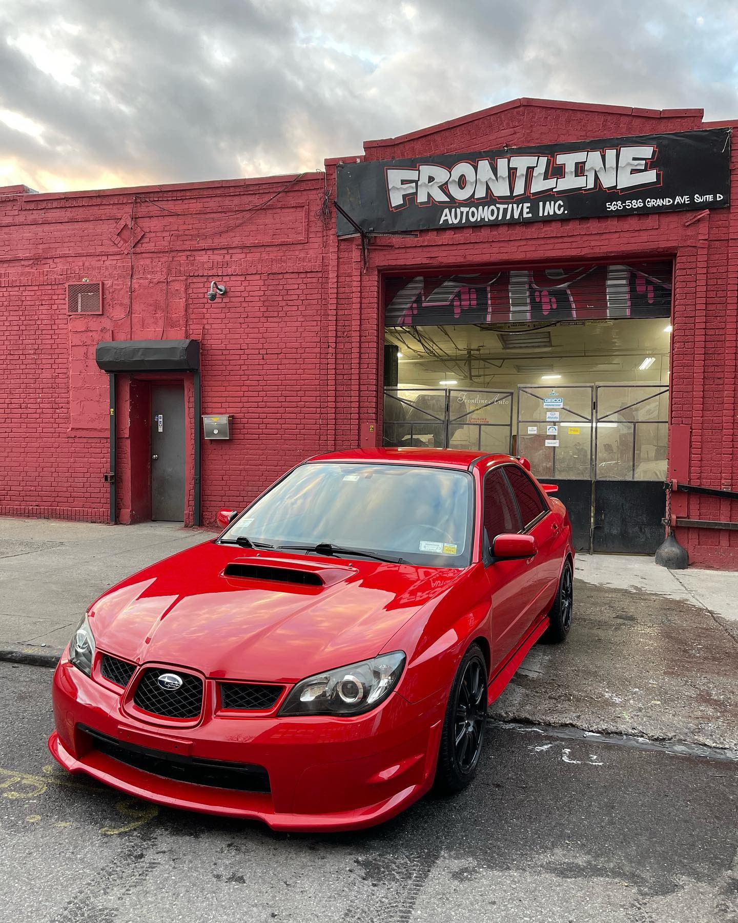 Red Subaru WRX sport sedan after collision repair