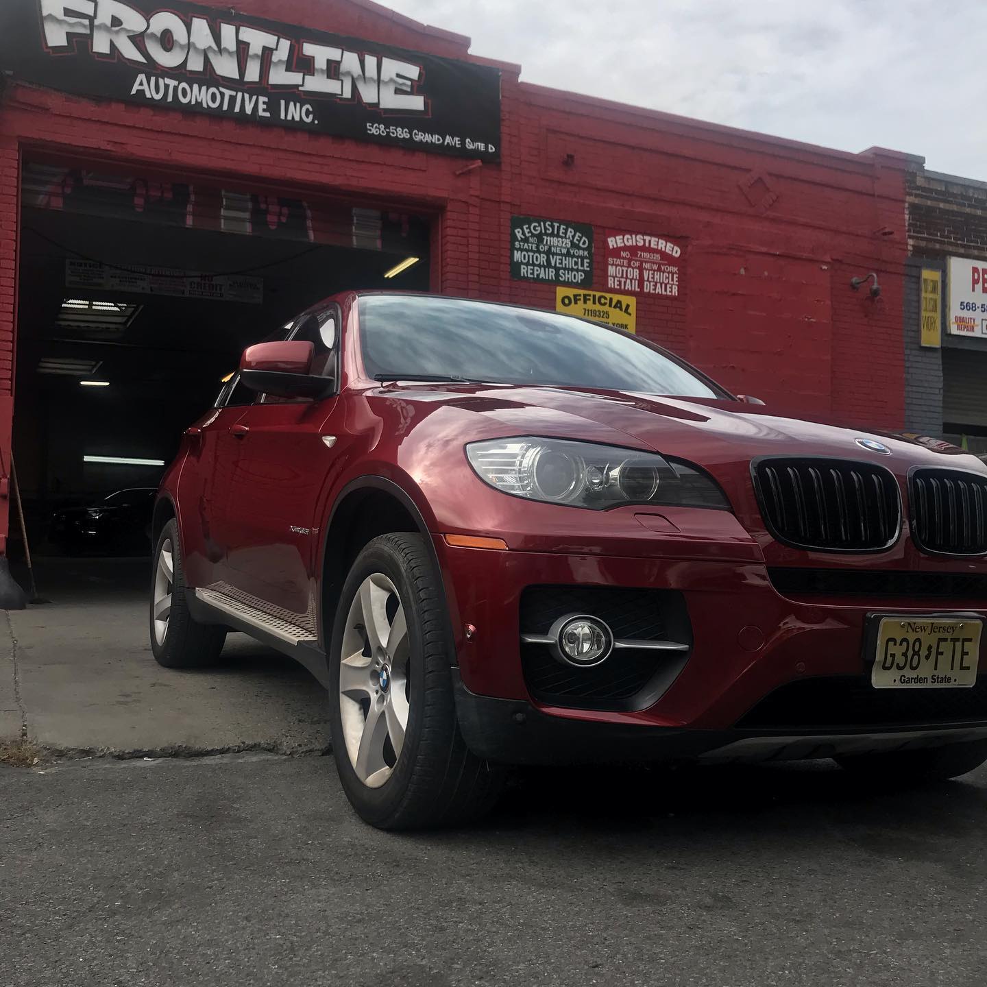 Red BMW X6 luxury SUV after paint and body refinish